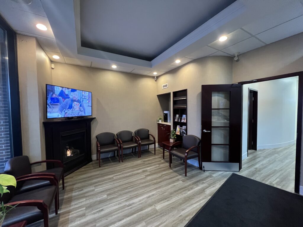 Waiting room with fireplace and TV