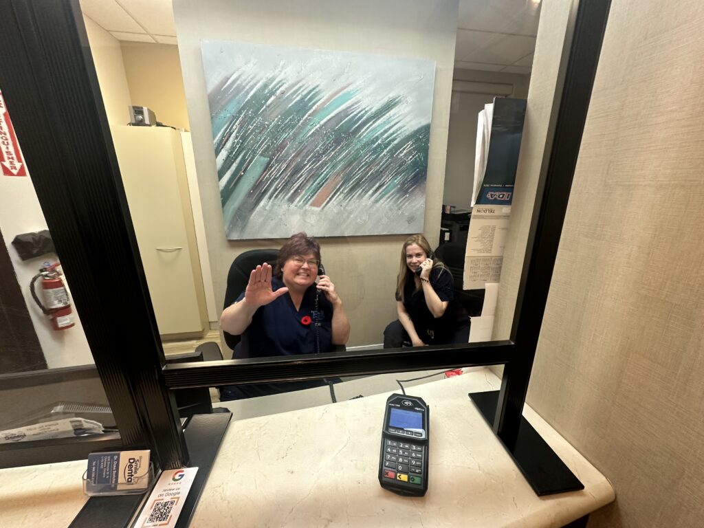 The front desk team waving hello