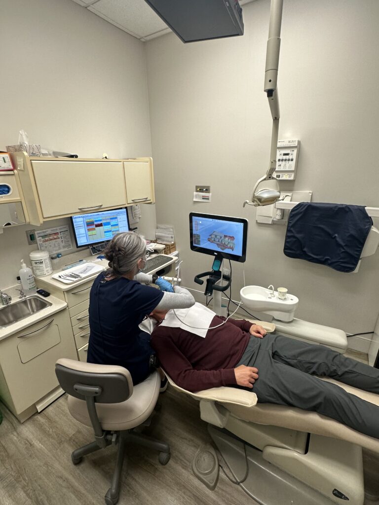 A hygienist caring for a patient in the chair